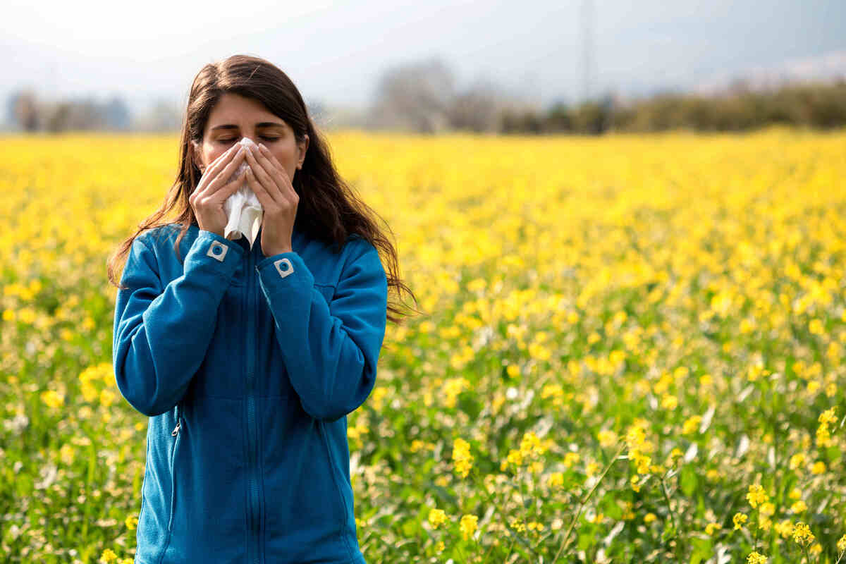 Woman with runny nose in a field